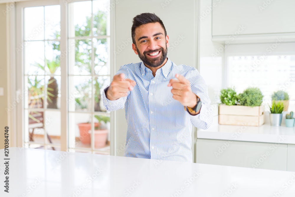 Handsome hispanic business man Pointing to you and the camera with fingers, smiling positive and cheerful
