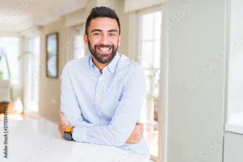 Handsome hispanic business man happy face smiling with crossed arms looking at the camera. Positive person.