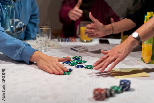 Friends play poker, the winner takes the chips of the money bet or pot.