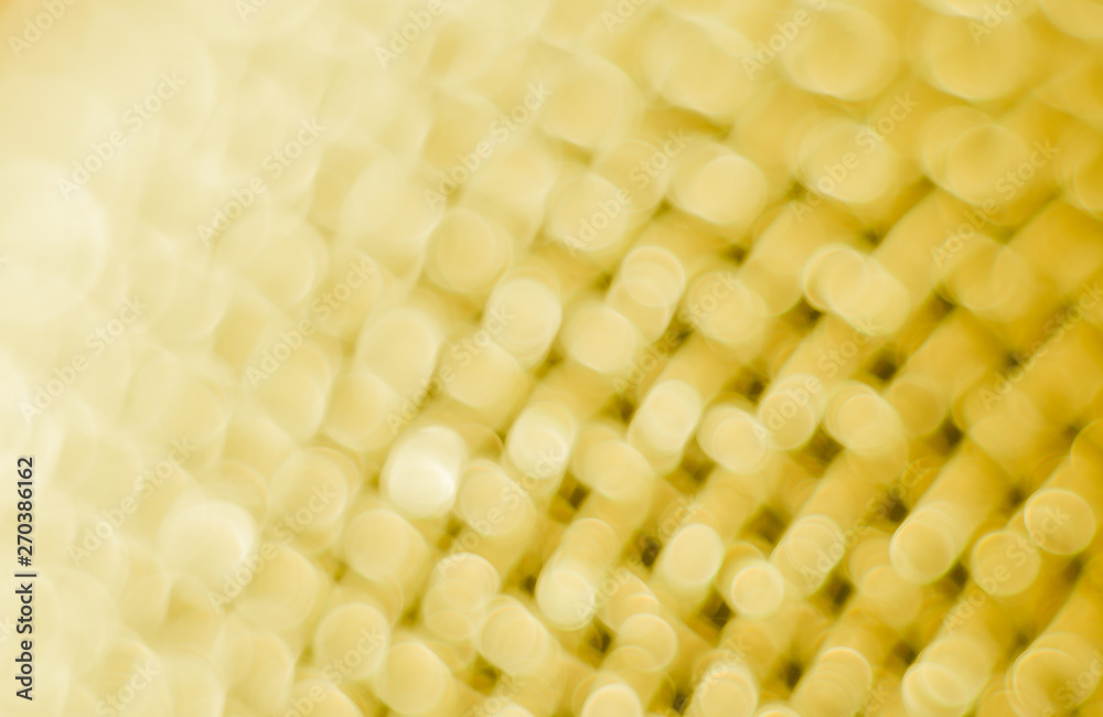 Abstract blurred yellow background. Texture of a metal mesh. Abstract blurred yellow background. Texture of a metal mesh.