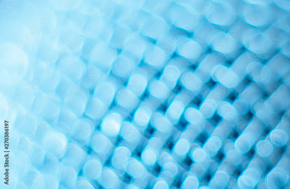 Abstract blurred blue background. Texture of a metal mesh.