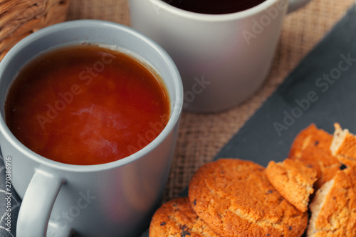 Tea with cookies on sackcloth background close up © NewFabrika