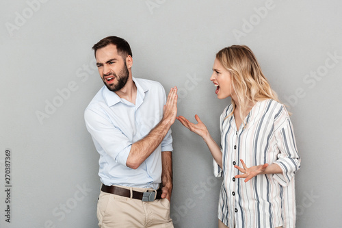 Photo of furious couple in casual clothes having problems and arguing