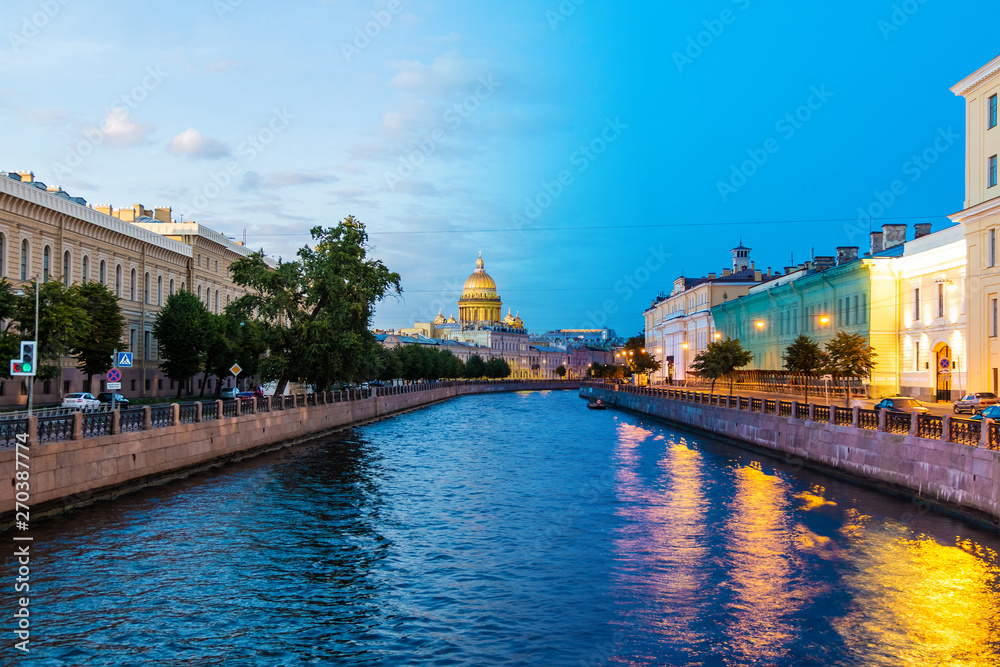 Time-lapse collage of day to night transition. Beautiful view of the Moyka River and historic buildings from the Potseluev Bridge, Saint Petersburg, Russia