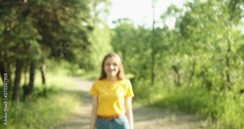 Beautiful girl going and dancing to the camera . Natural landscape 
