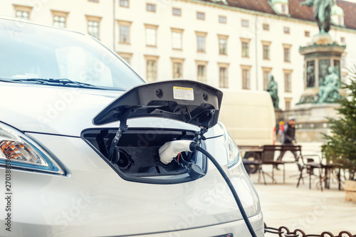 Photography Close-up modern electric car pugged with fast charger at charging