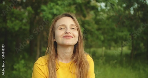 Beautiful girl smiling and  looking at the camera in the forest