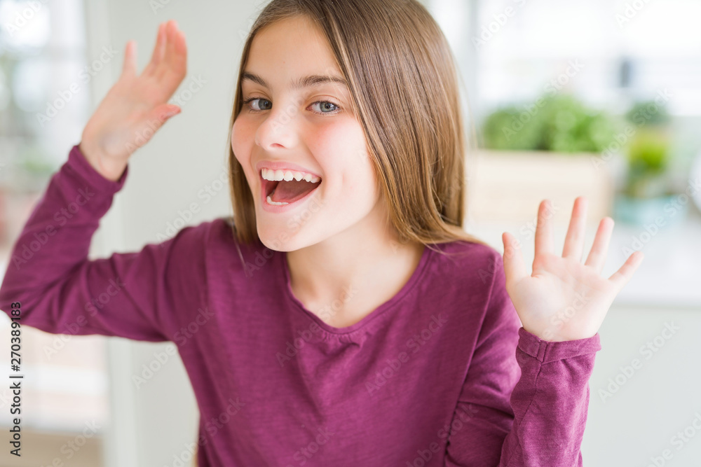 Beautiful young girl kid celebrating crazy and amazed for success with arms raised and open eyes screaming excited. Winner concept Beautiful young girl kid celebrating crazy and amazed for success with arms raised and open eyes screaming excited. Winner concept