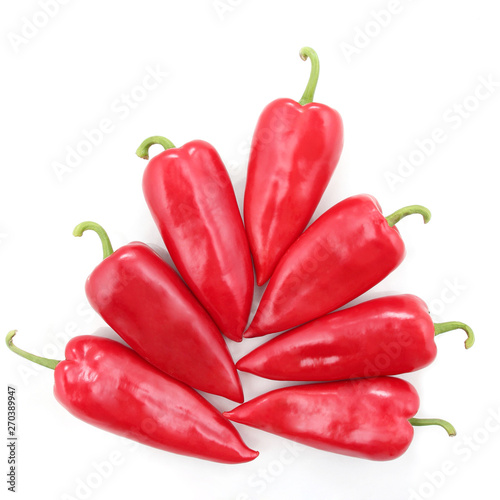 seven bright red sweet peppers on a white background. healthy fresh vegetables and food