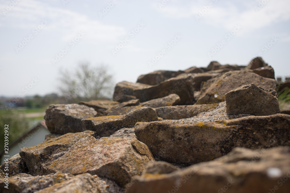 Close up of various shaped stone wall of medieval fortress.Top of various shaped stone wall of medieval fortress.