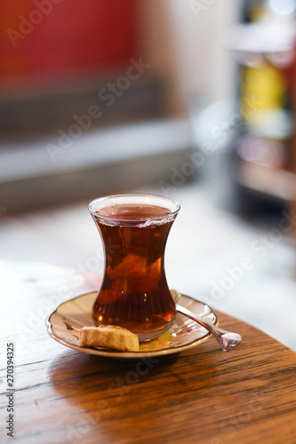Tea in traditional turkish glass on a table