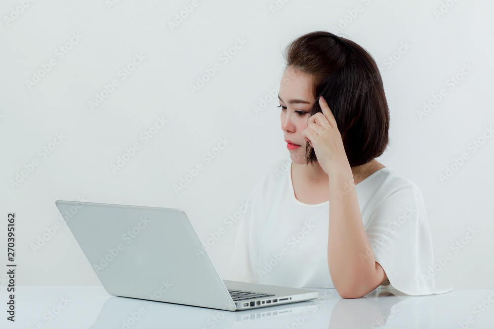 Asian beautiful woman Sitting in a white shirt On the front desk, there is a laptop computer placed. Expression There is work stress. With a white background Asian beautiful woman Sitting in a white shirt On the front desk, there is a laptop computer placed. Expression There is work stress. With a white background