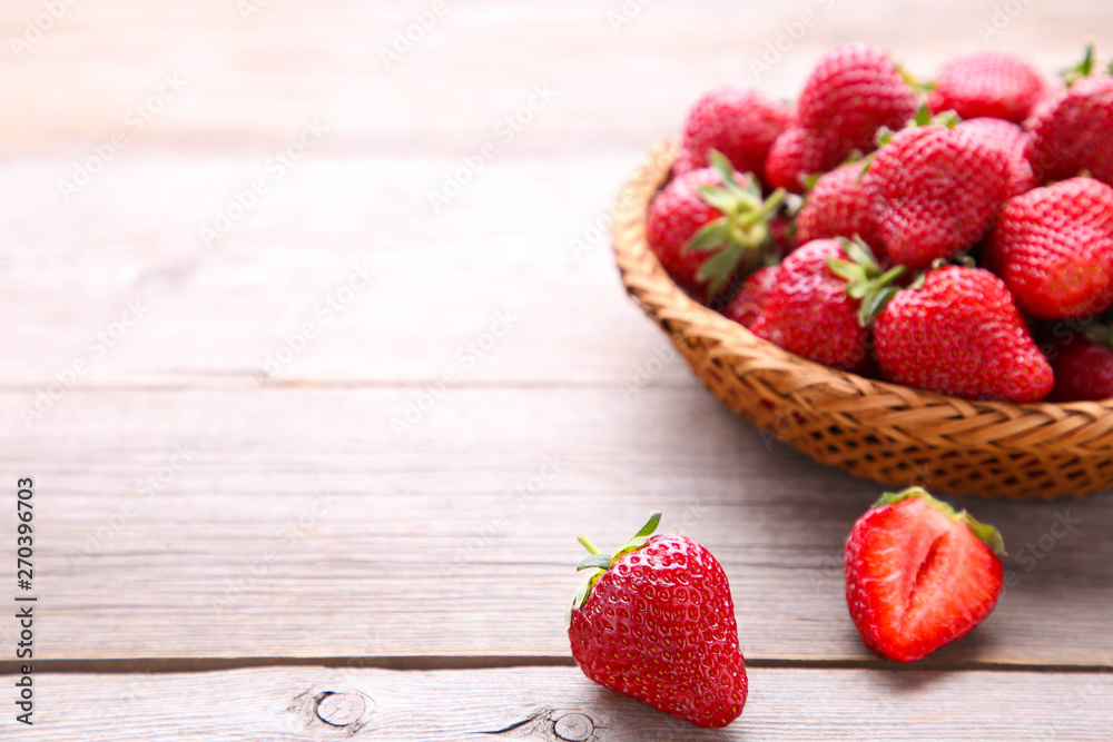 Strawberries in the basket on grey wooden background Strawberries in the basket on grey wooden background