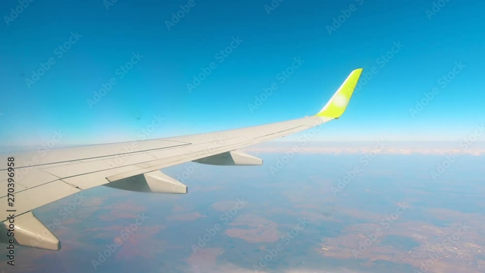 Wing of an aircraft flying in the sky