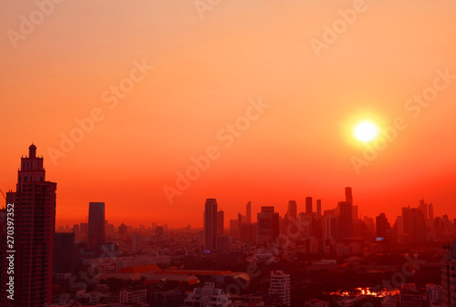 Marvelous sunset over the skyscrapers in vibrant red and orange color 