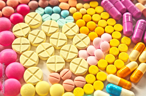 Colorful drug pills texture pattern background in variety types of medicine is capsule ,tablet in pharmacy that are solid pharmaceutical oral dosage form of medication for treatment disease in patient