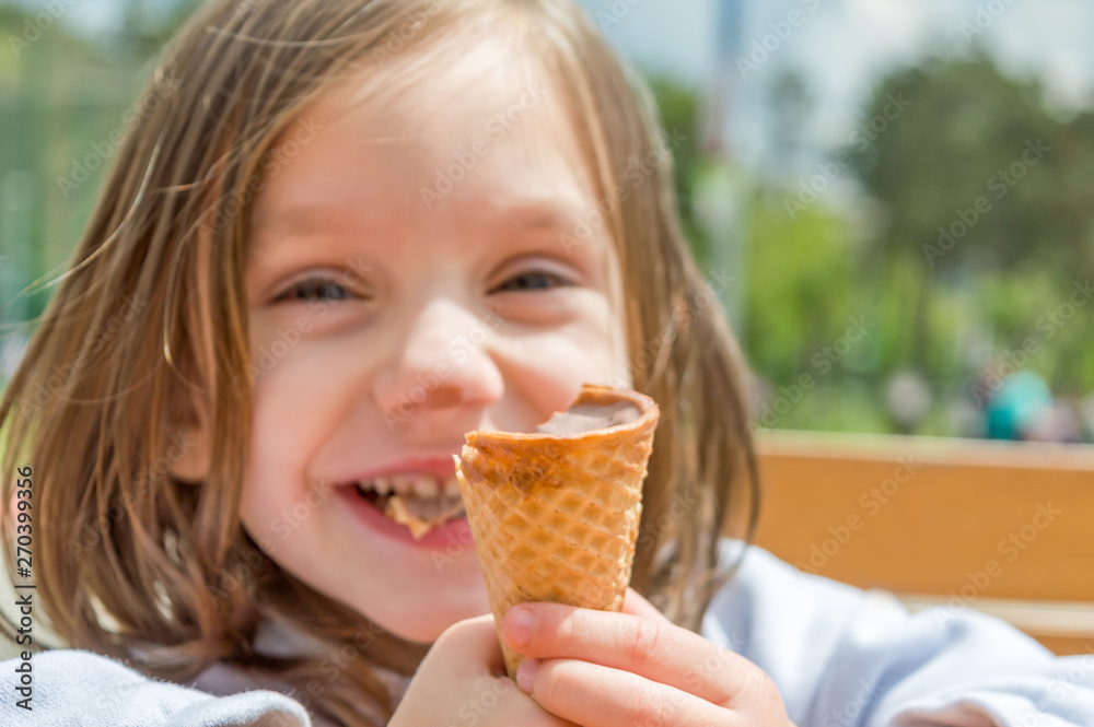 Blurred background with funny little girl eating ice cream Blurred background with funny little girl eating ice cream