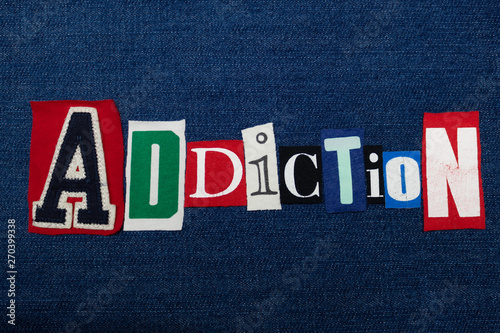ADDICTION text word collage, colorful fabric on blue denim, abuse and treatment concept, horizontal aspect