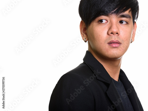 Studio shot of cool handsome Asian man looking back