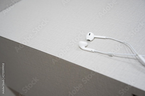 white earphone on the wooden table