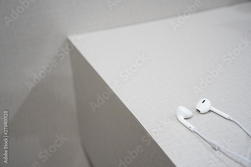 white earphone on the wooden table