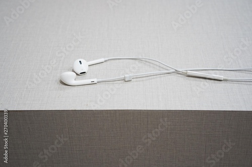 white earphone on the wooden table