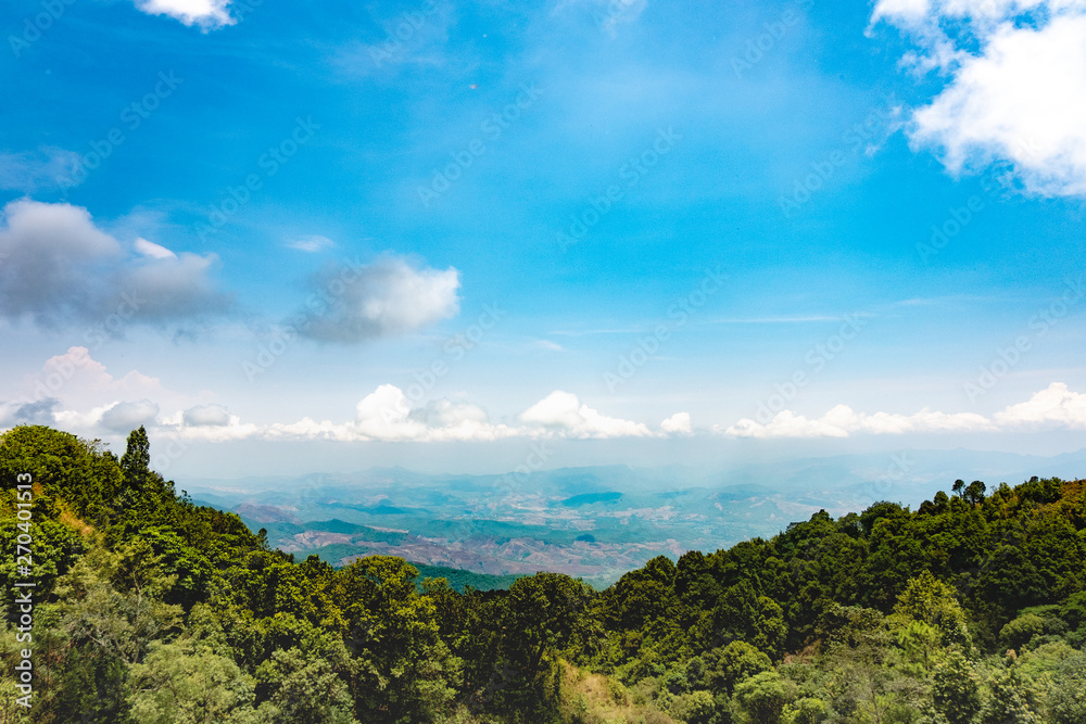 The beautiful mountain landscape has a hilltop covered with forests and cloudy skies in Thailand.