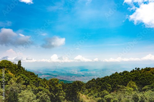 The beautiful mountain landscape has a hilltop covered with forests and cloudy skies in Thailand.