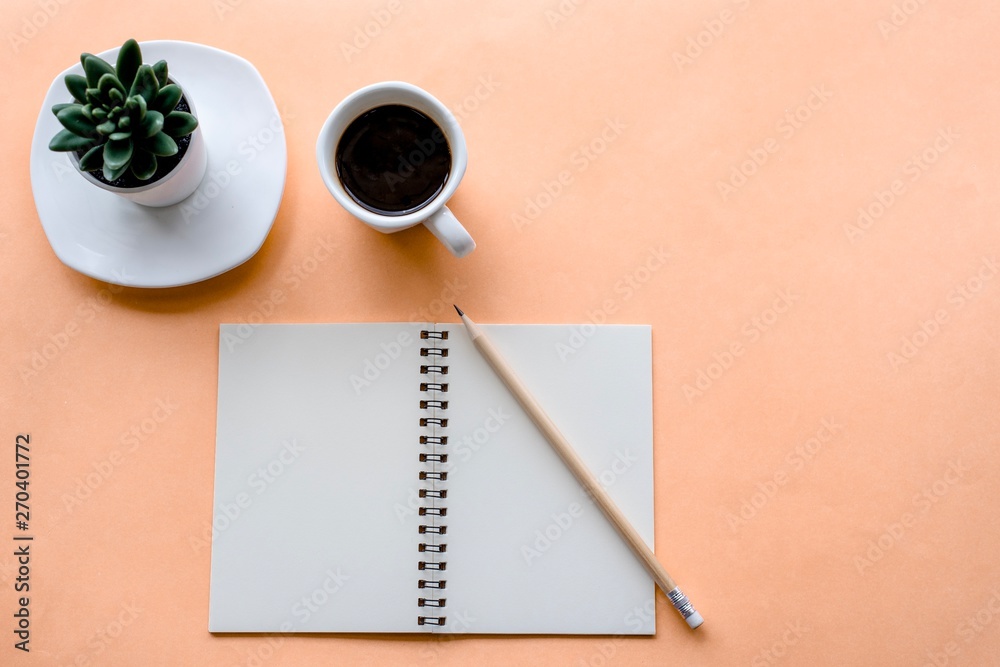 Top view office desk with notebook and coffee cup Top view office desk with notebook and coffee cup