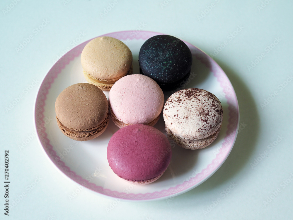 Delicious and colorful macaroon places on white plate with selective focus. Delicious and colorful macaroon places on white plate with selective focus.