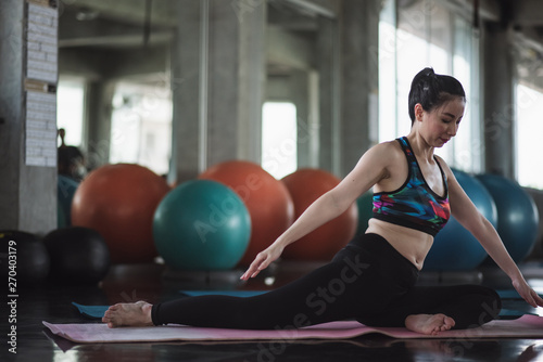 Attractive woman doing yoga exercise at the gym. © ic36006