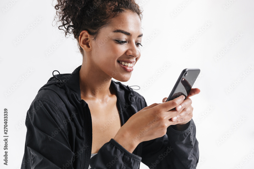 Sports fitness african woman using mobile phone. Sports fitness african woman using mobile phone.