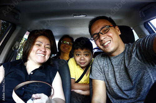Filipino family inside a car © junpinzon