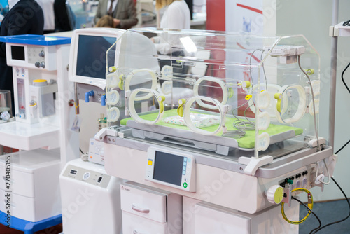 Modern Baby Incubator Isolated. Empty infant incubator in an hospital room. Nursery incubator in hospital. Box for carrying premature babies