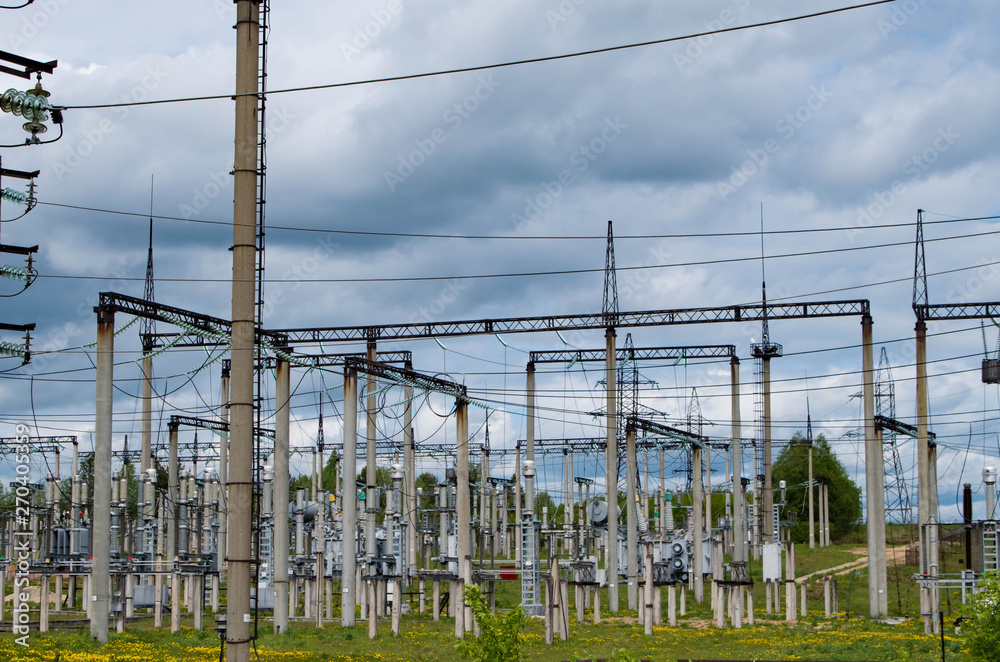Electricity distribution station. Lots of wires, poles and shields. Electricity distribution station. Lots of wires, poles and shields.