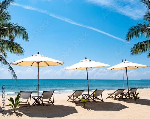 Beach umbrellas and chairs overlooking the beautiful sea and sky. Used to shade tourists while enjoying relaxation © Waraphot