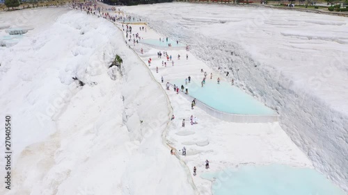 Crowds of tourists on the terraces of white limestone. Pamukkale, Turkey. Aerial footage 4k