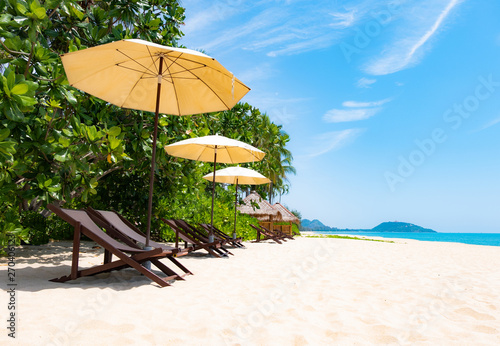 Beach umbrellas and chairs overlooking the beautiful sea and sky. Used to shade tourists while enjoying relaxation
