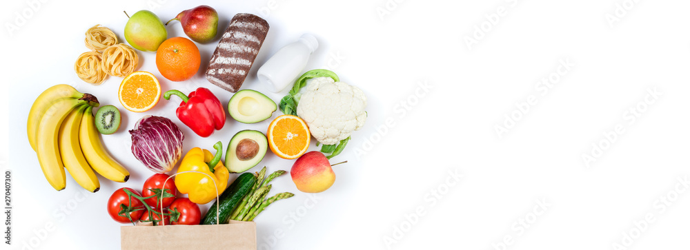 Healthy food background. Healthy food in paper bag bread, milk, vegetables and fruits on white background. Shopping food supermarket concept. Long format with copy space