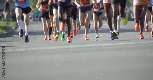 4K - A group of marathoners. Slow motion legs of athletes