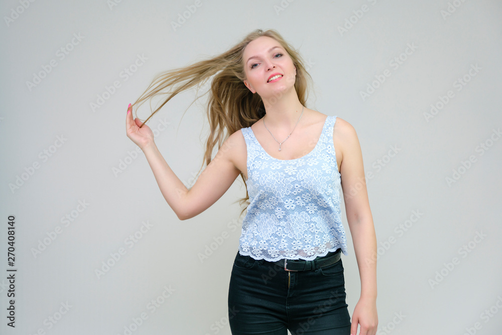 Life is beautiful and I like everything here. I am satisfied with life and I wish you. Portrait of a smiling beautiful blonde girl on a gray background in various poses. Life is beautiful and I like everything here. I am satisfied with life and I wish you. Portrait of a smiling beautiful blonde girl on a gray background in various poses.