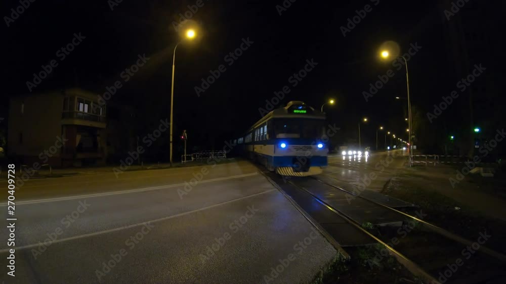 City Traffic At Night And Train Crossing