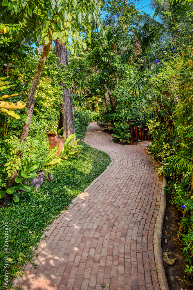 Naklejka premium Tropical gardens around a swimming pool in Pattaya, Thailand