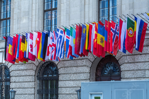 Canvas Print Flags of almost all countries of the northern hemisphere on the facade the building of Hofburg palace in Vienna, Austria