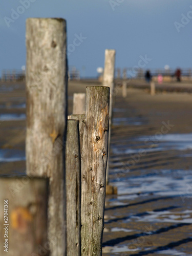 Wooden poles at the beach in Sankt Peter-Ording