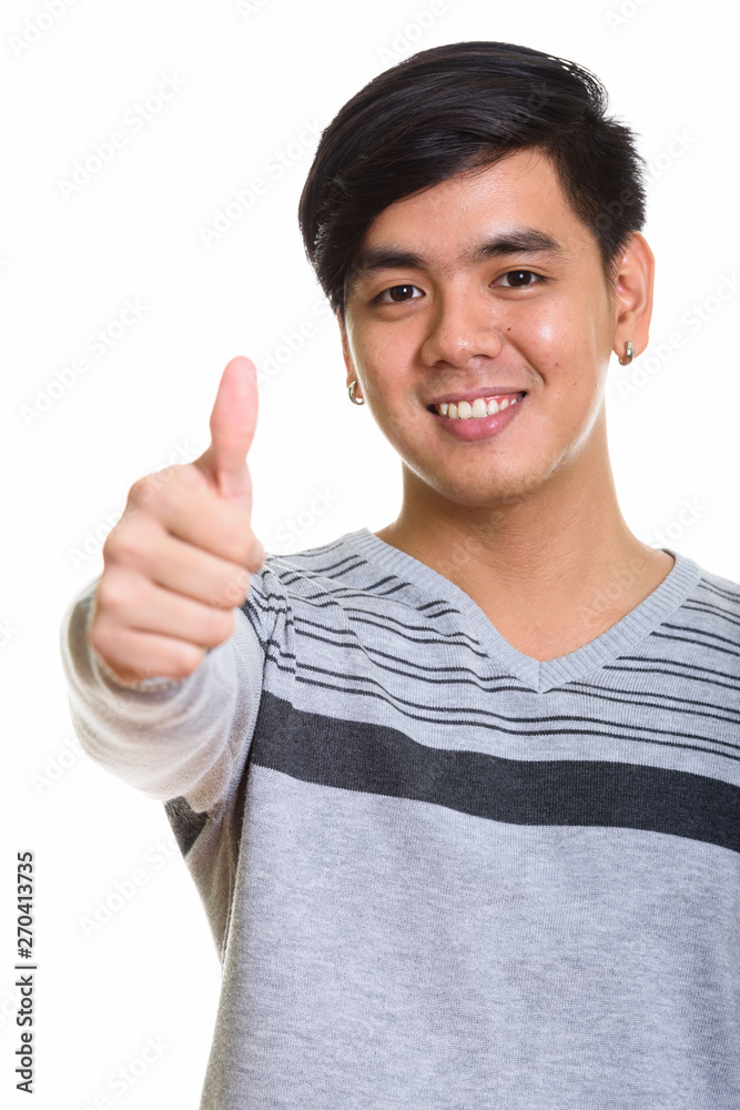 Close up of happy Asian man smiling and giving thumb up Close up of happy Asian man smiling and giving thumb up