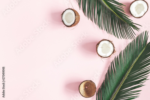 Summer composition. Coconut, palm leaf on pastel pink background. Summer concept. Flat lay, top view, copy space