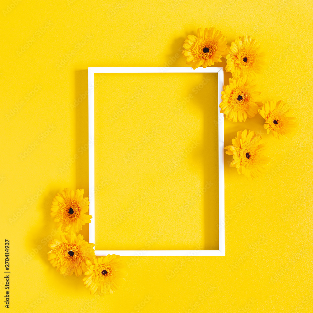 Flowers composition. Yellow gerbera flowers, photo frame on yellow background. Flat lay, top view, copy space - obrazy, fototapety, plakaty 
