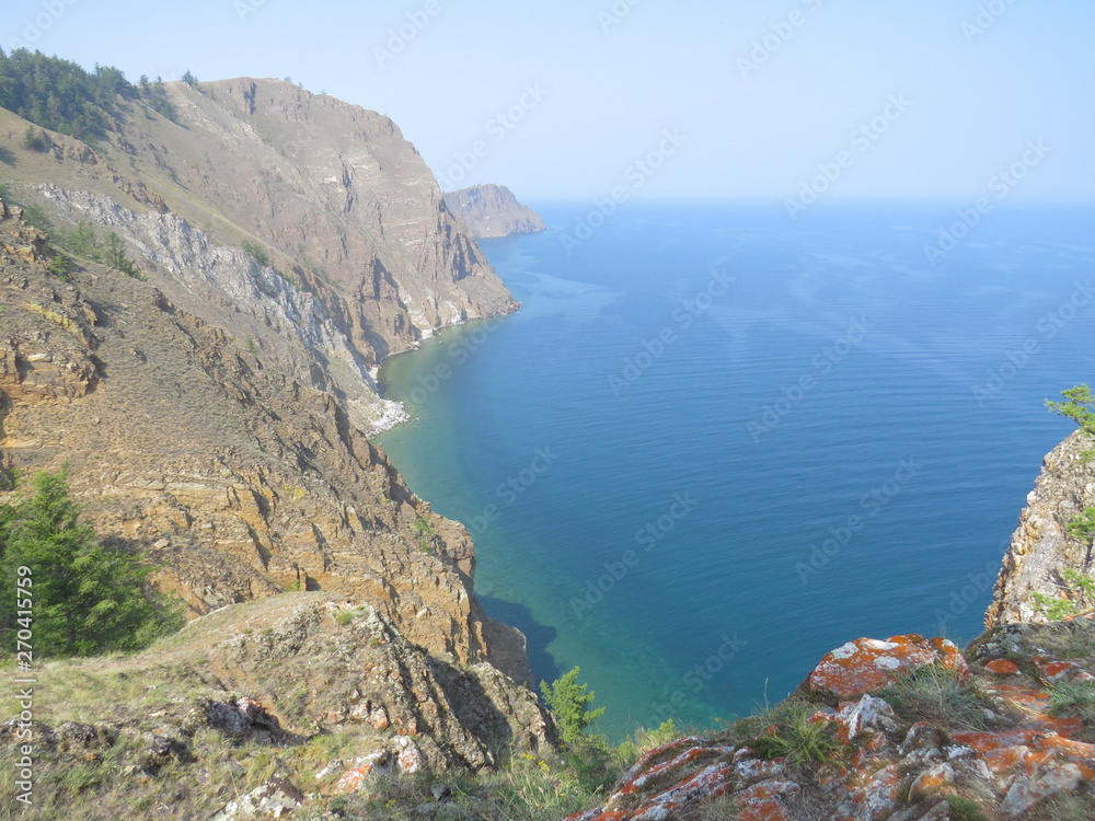 Lichen-covered rocks, pines, lake view. Landscape Olkhon Island.