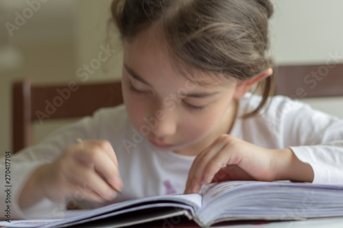 she is making her homework. The primary school student is making herself homework
